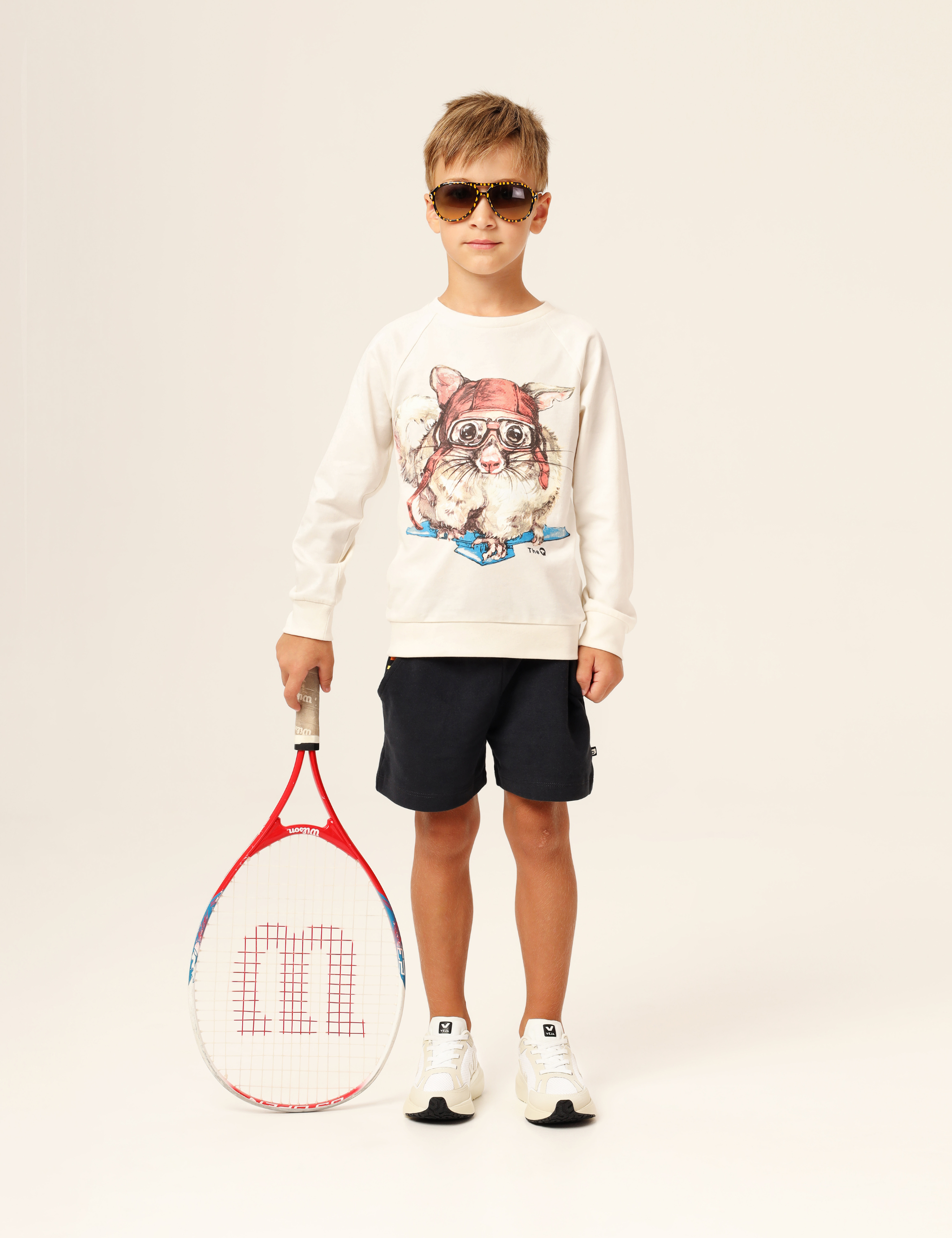 Child wearing organic cotton kids top with long raglan sleeves and sugar glider pilot on a paper airplane print – unisex, plastic-free and hypoallergenic.